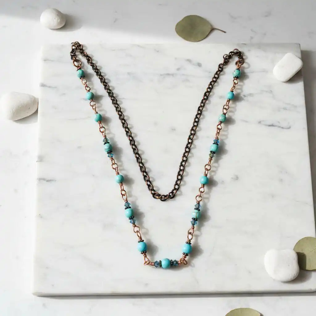 Wire Wrapped 24 Inches Copper Turquoise Necklace displayed on a marble surface with turquoise and copper beads.