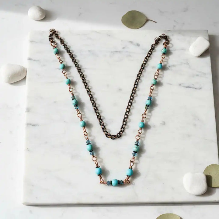 Wire Wrapped 24 Inches Copper Turquoise Necklace displayed on a marble surface with turquoise and copper beads.
