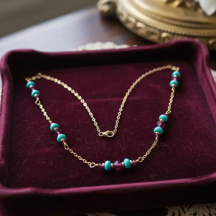 Wire Wrapped Gold Filled Pink Turquoise Gemstone Necklace displayed on a velvet background, showcasing vibrant turquoise and fuchsia crystals.