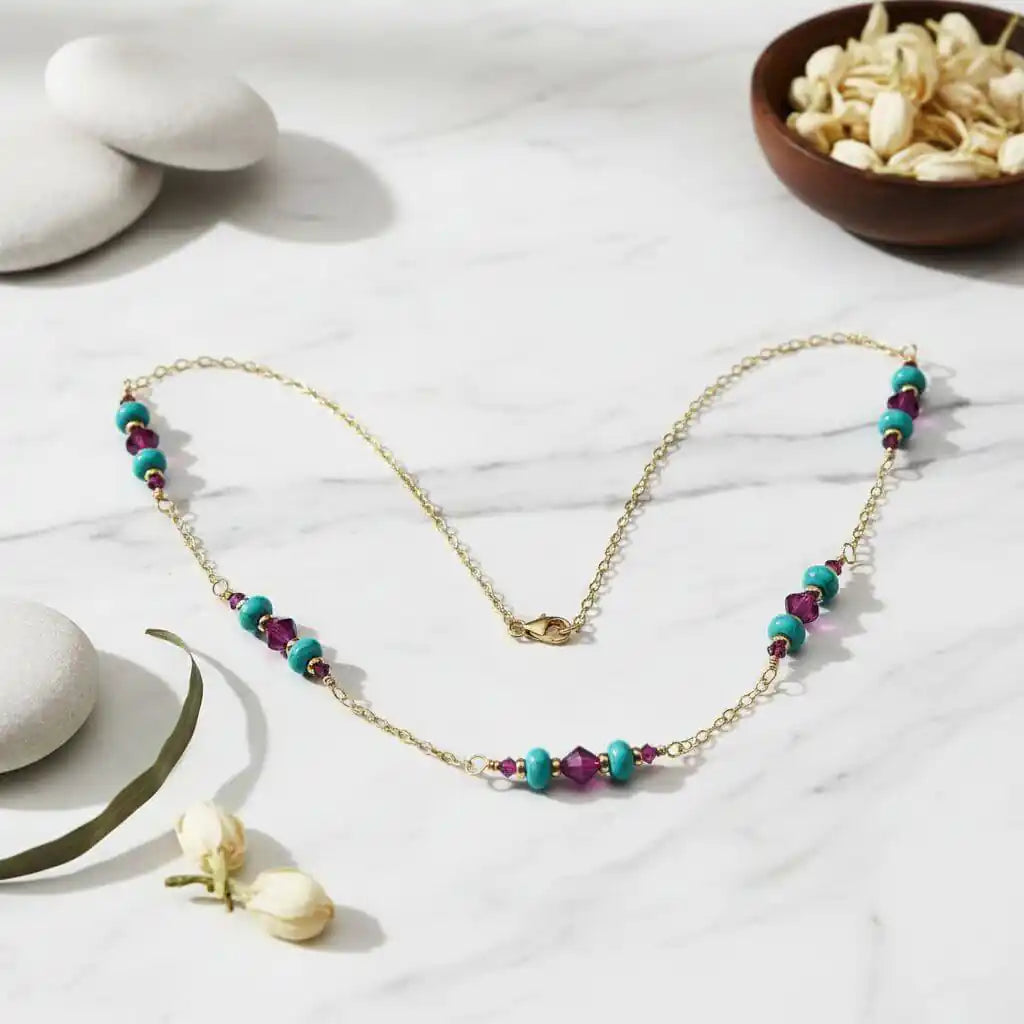 Wire Wrapped Gold Filled Pink Turquoise Gemstone Necklace displayed on marble background with decorative elements