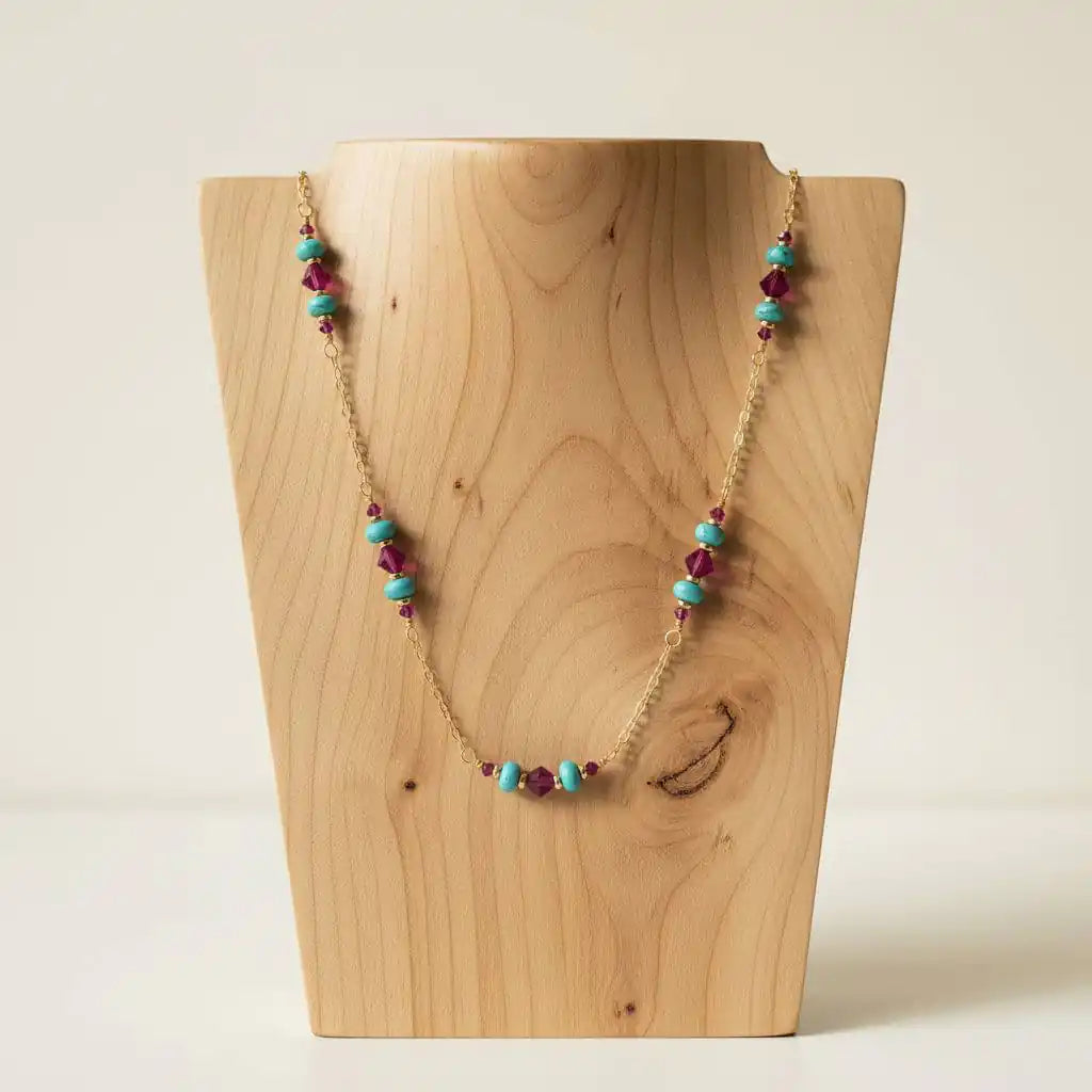 Wire Wrapped Gold Filled Pink Turquoise Gemstone Necklace displayed on a wooden bust, showcasing vibrant turquoise and fuchsia beads.