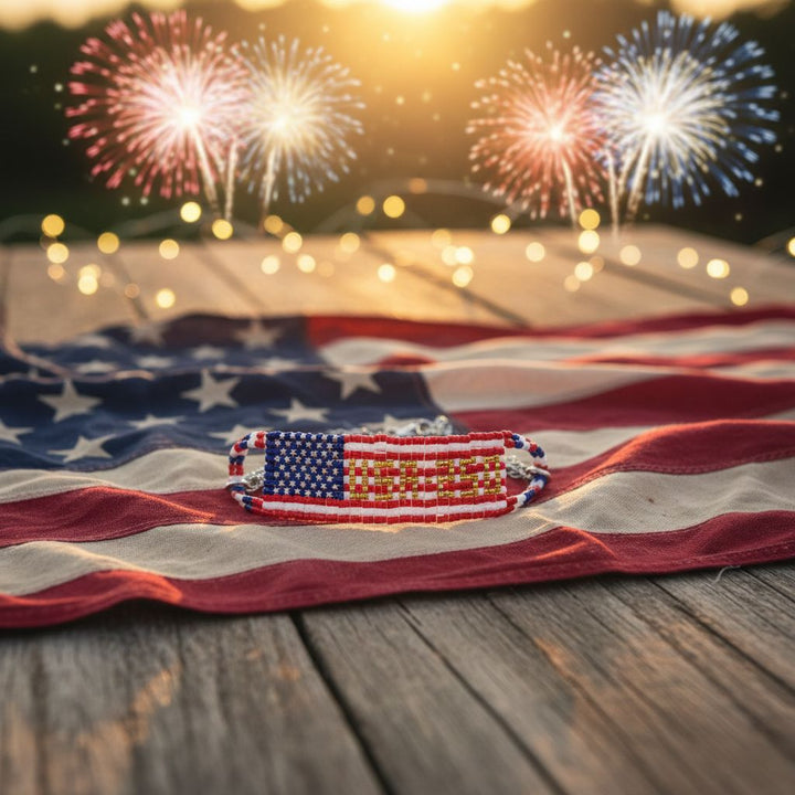 USA 250th Anniversary Beaded Bracelet By Alexa Martha on American flag with fireworks in the background.