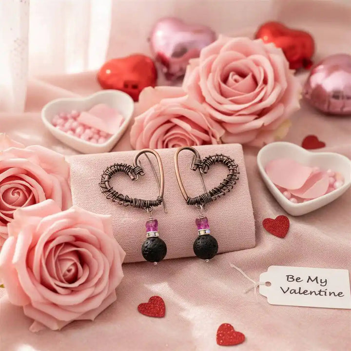 Copper Sculpted Heart Hoop Crystal Lava Rock Earrings displayed on a soft pink fabric with roses and Valentine&