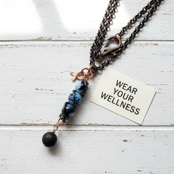 Child Abuse Awareness Agate Necklace With Lava Rock Bead featuring blue agate beads and a lava rock charm on a copper chain.