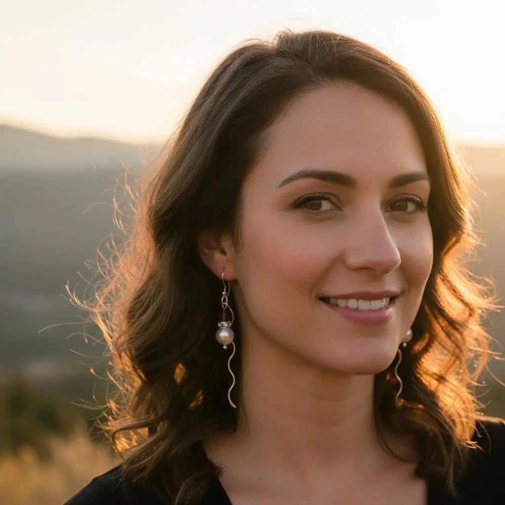 Innovative 925 Silver Swarovski Crystal Pearl Ear Threaders worn by a woman against a sunset background.