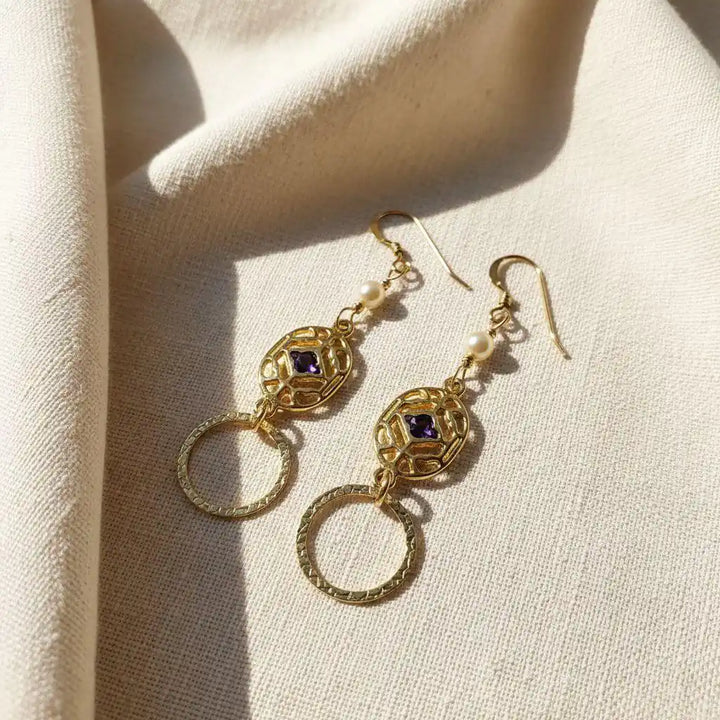 14 K Gold Filled Purple Crystal Circle Filigree Earrings showcasing elegant design with purple crystals and gold accents.
