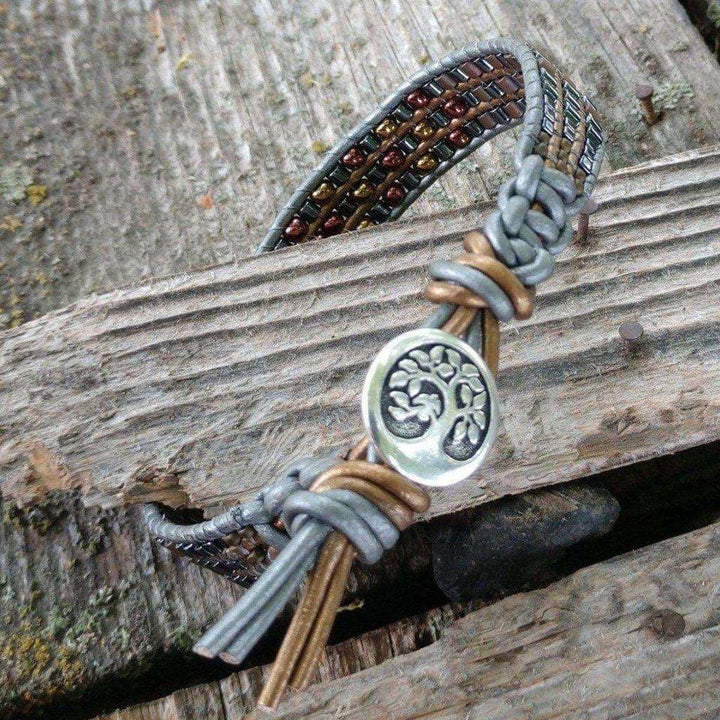 AMD1033 Men's leather wrap bracelet featuring a Tree of Life design with intricately beaded earth-tone craftsmanship.